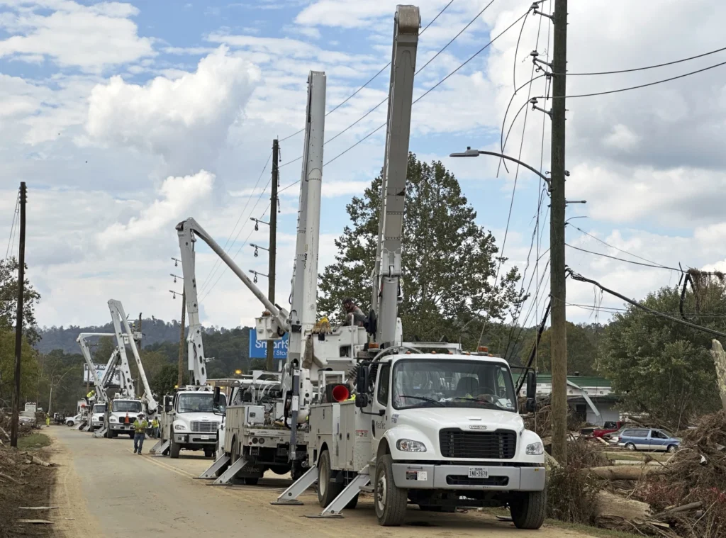 Contractors for Duke Energy rebuild destroyed electrical lines near the Swannanoa River in Asheville, N.C., Friday, Oct. 4, 2024 (AP photo/ Jeff Amy)